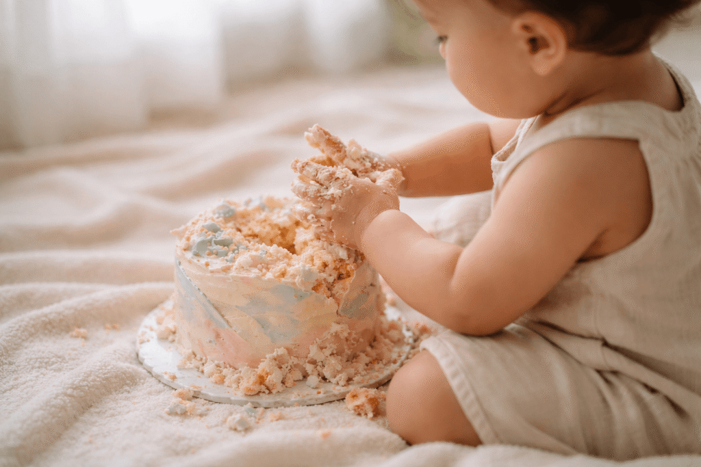 10 Creative Smash Cake Ideas for 1st Birthday Celebration 2 happy baby laughing while smashing first birthday cake